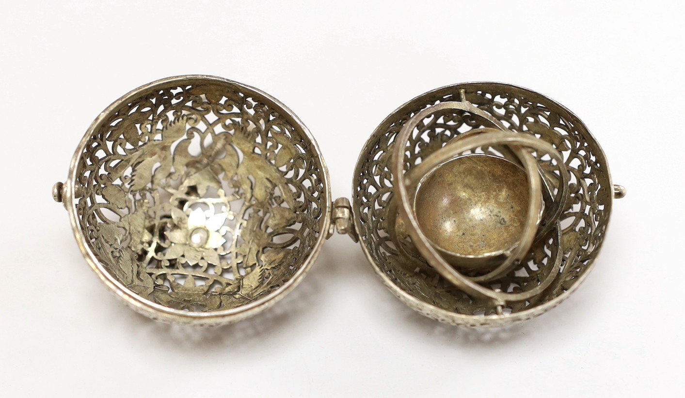 A Chinese spherical ornately worked metal perfume holder, 5.2cm